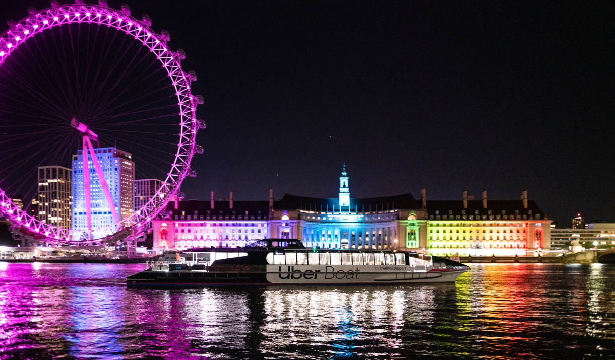 Uber Boat by Thames Clippers sailing past the London Eye at night